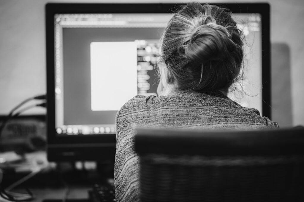 Graphic designer sitting in front of the computer screen.