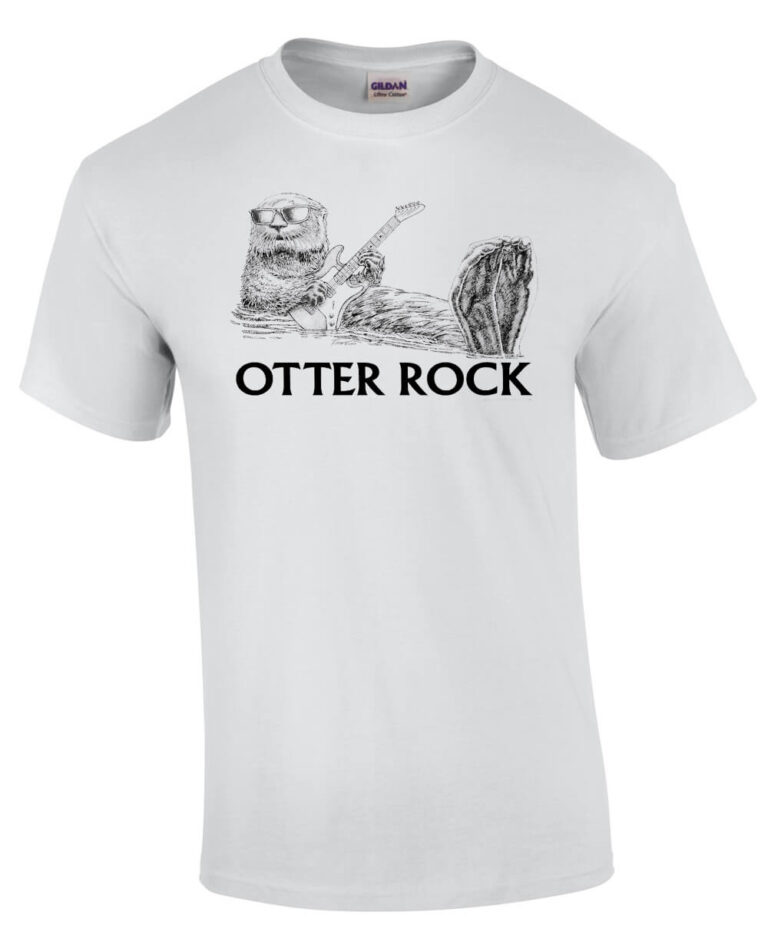 White t-shirt with otter wearing sunglasses, floating on his back playing guitar. Caption: Otter Rock